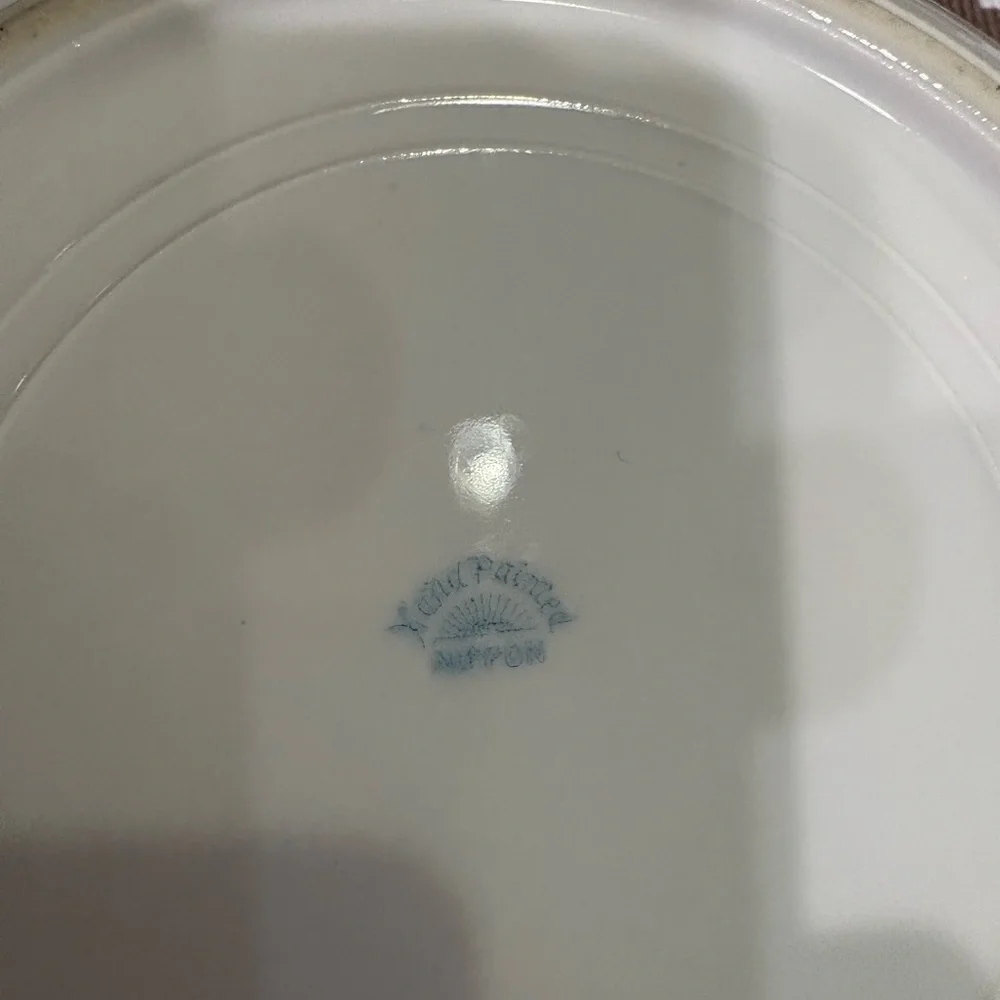 Nippon Hand-painted bowl featuring a floral motif & butterflies with gold trim